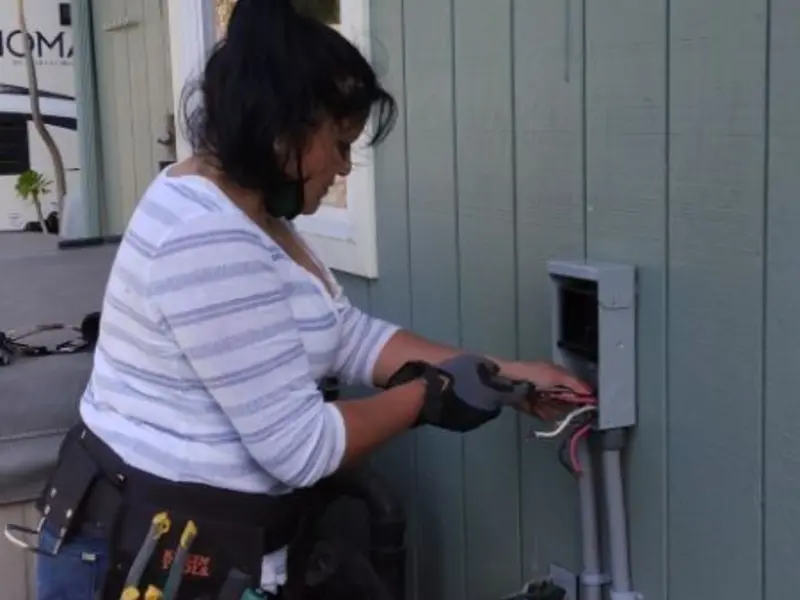 Licensed electrician wiring an exterior subpanel in Jupiter